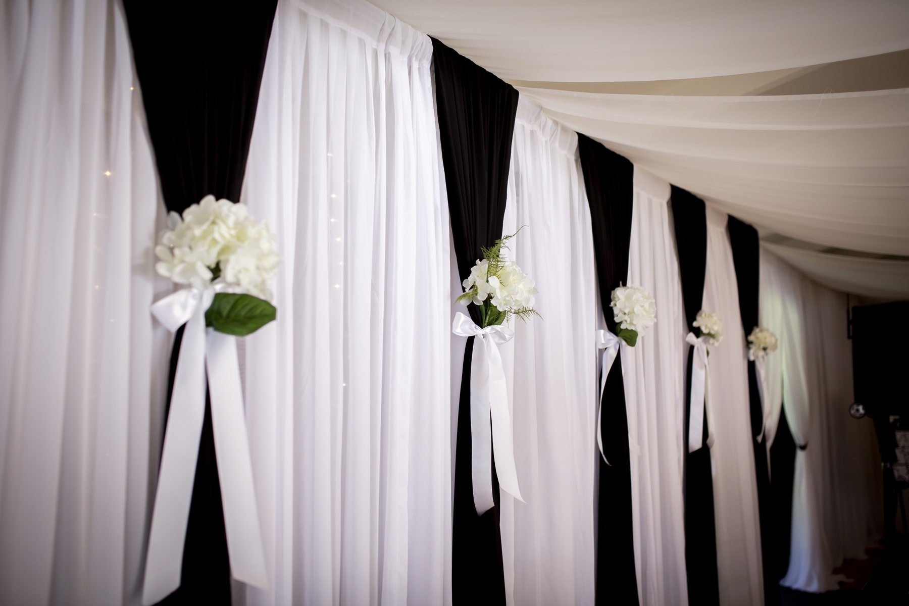 White draping with floral details photographed by Still Vision